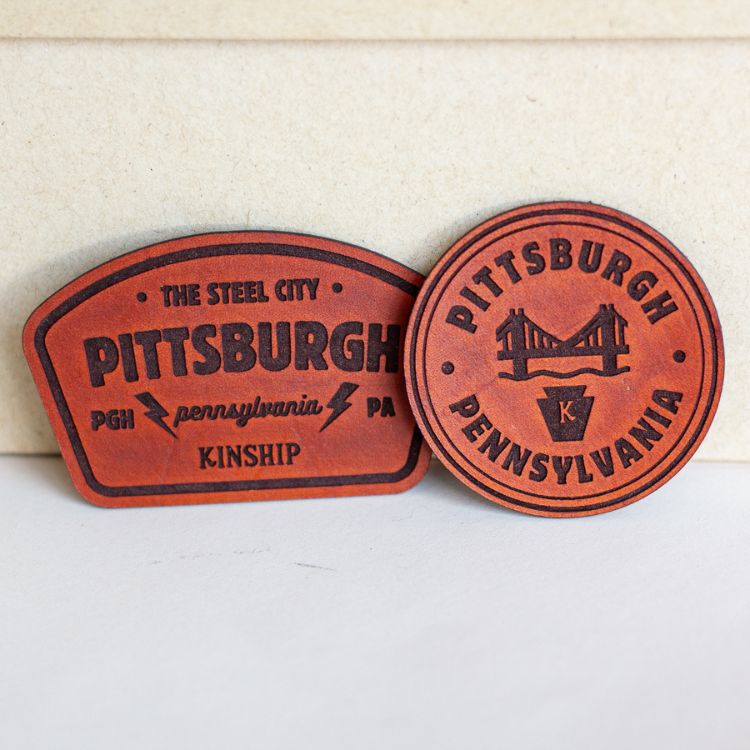 Cozy Plus Sign Reversible Throw with Leather Patch